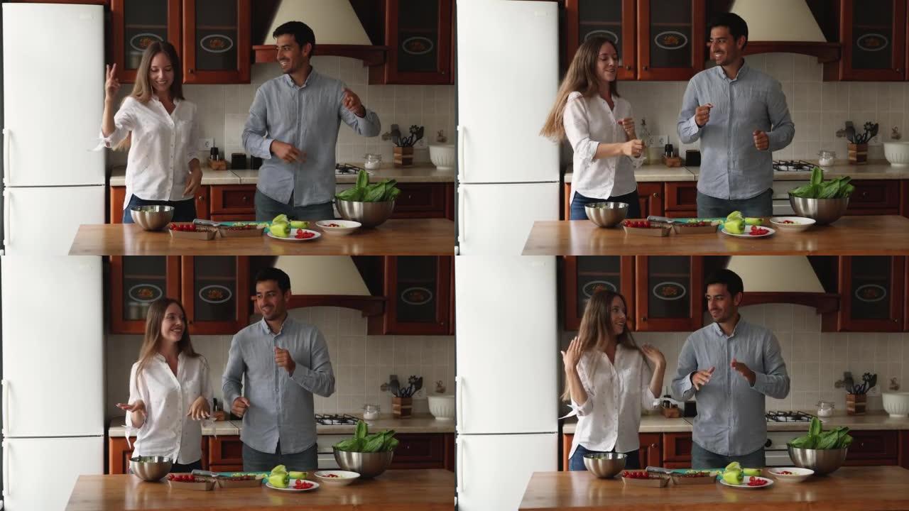 千禧一代夫妇在一起做饭时在厨房跳舞