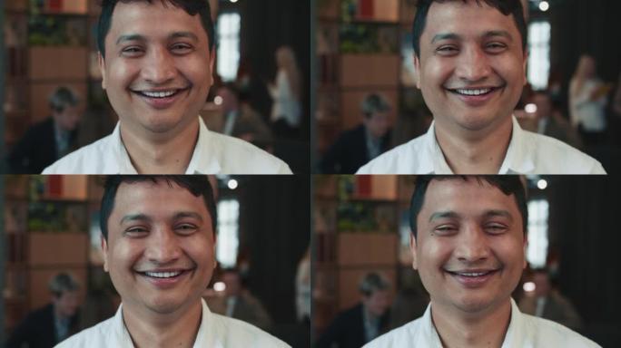 35-40岁的印度企业家领袖、创业公司经理在工作时微笑的特写照片。
