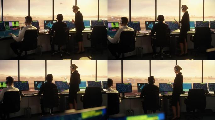 日落时在现代机场塔中工作的多元化空中交通管制团队。办公室里满是台式电脑显示屏，配有导航屏幕，飞机飞行