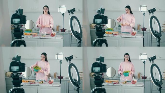 拍摄时，一名妇女正在录像带里做饭。在线vlog概念，女性博主录制视频，在线流媒体概念。