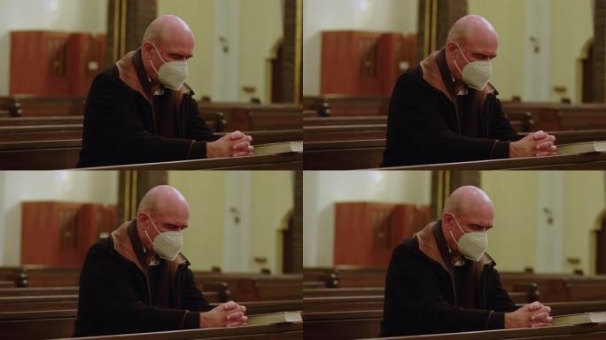 新型冠状病毒肺炎危机期间，男子在大教堂祈祷