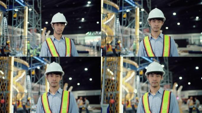 在重工业制造工厂穿着安全制服计划工作的专业货运工人的肖像。