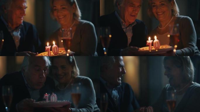 一位高级男子正在吹蜡烛，用妻子用爱做的蛋糕在家里庆祝生日。
