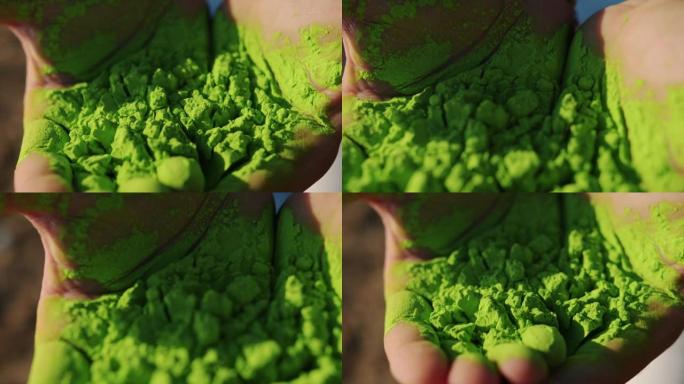 人们庆祝胡里节时，手掌充满绿色粉末的特写镜头