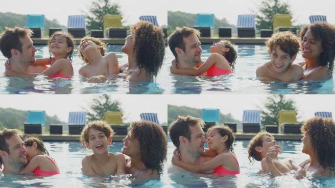 暑假一起在游泳池放松的多种族家庭肖像 -- 慢动作拍摄