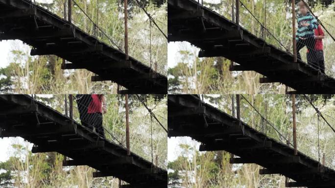 阿根廷科尔多瓦省圣罗莎德卡拉姆奇塔的圣罗莎河上的人行吊桥上的模糊儿童。