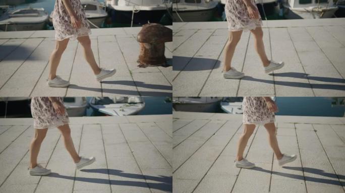 低矮的女人在码头上行走