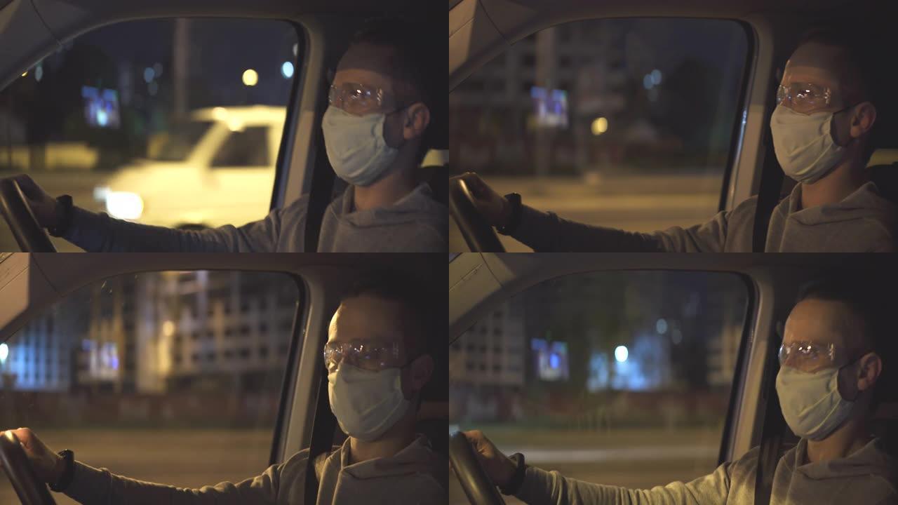 戴着口罩和防护眼镜的男子在夜间道路上驾驶汽车