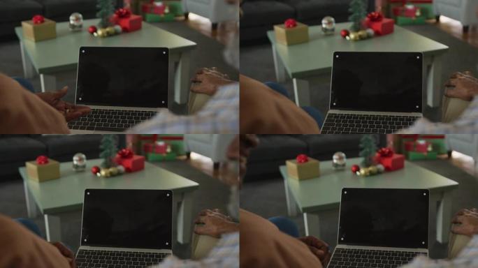 非裔美国老年夫妇在圣诞节时使用笔记本电脑的动画，屏幕上有复制空间