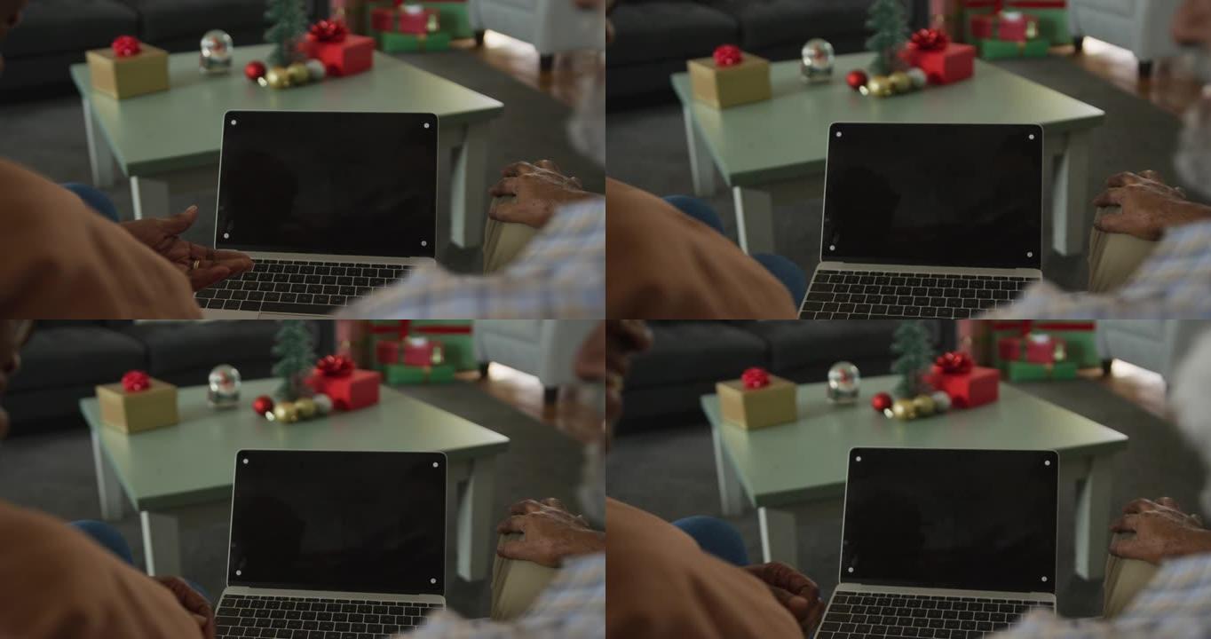 非裔美国老年夫妇在圣诞节时使用笔记本电脑的动画，屏幕上有复制空间