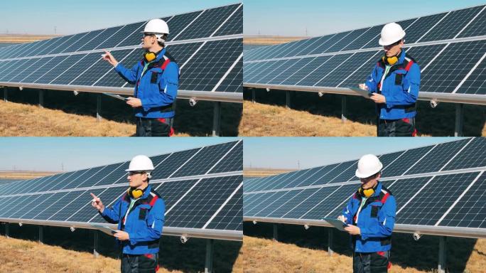 太阳能专家使用平板电脑监控太阳能农场