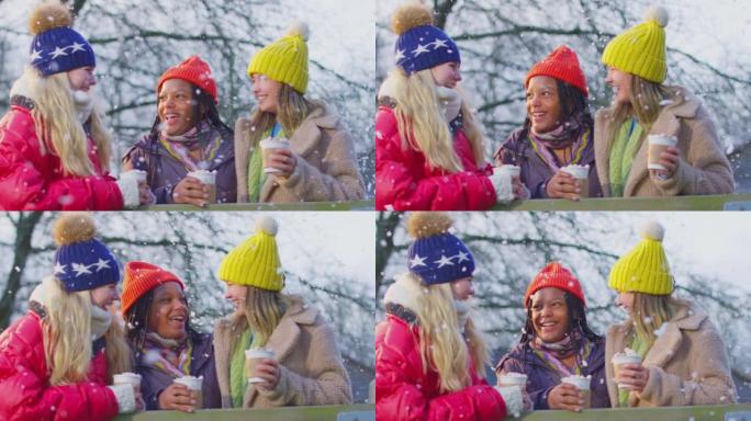 十几岁的女孩在下雪的冬天一起在乡下散步享受热巧克力的肖像 -- 慢动作拍摄