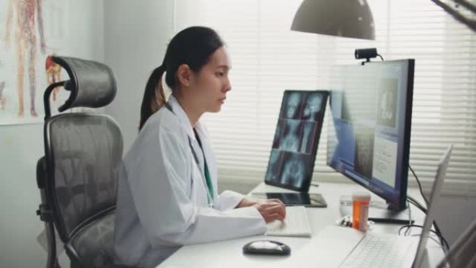 医生在医院的办公桌上使用计算机，医疗保健和医学概念