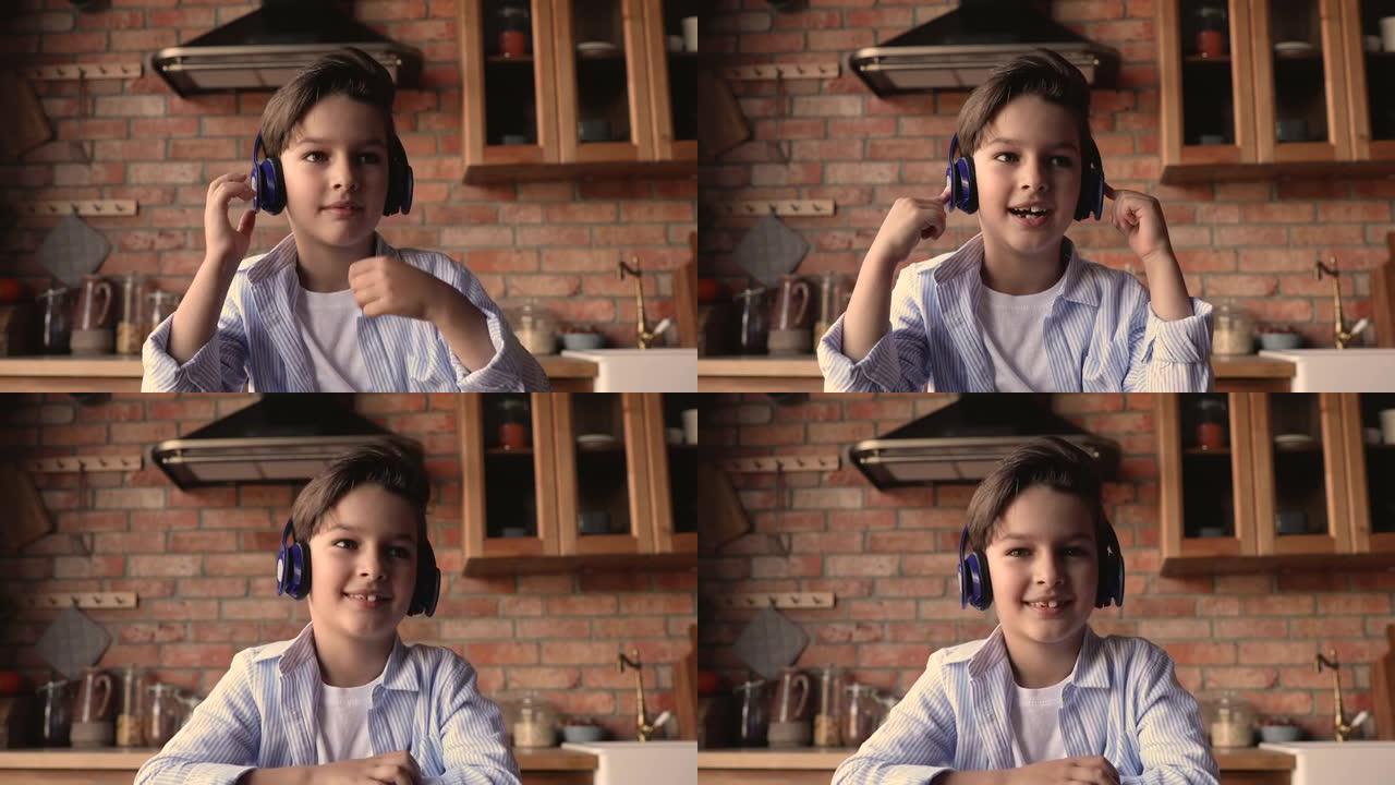 戴着耳机的可爱的小男孩参与视频通话课。