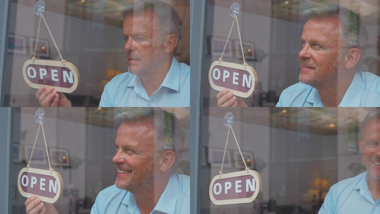 商店或咖啡馆内的成熟男性老板或员工从关闭到开放的圆形标志