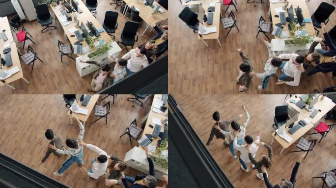 快乐的人们上班族在现代开放空间工作场所跳舞的高角度视角