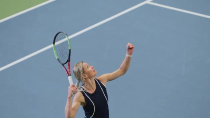 女子网球运动员在锦标赛期间用球拍击打击球。职业女运动员罢工成功。世界体育锦标赛。慢动作高角度宽镜头
