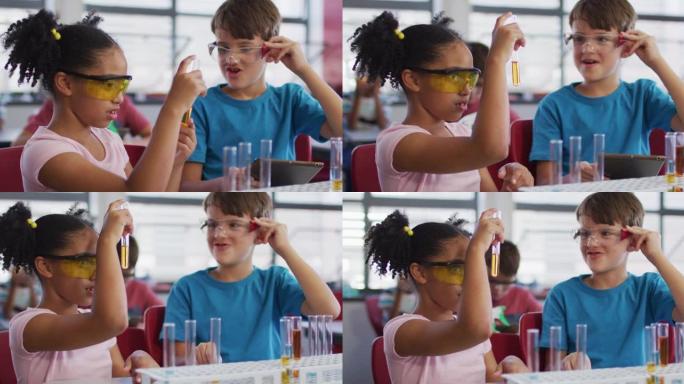 化学课上戴着防护眼镜的多样化种族学童拿着试管