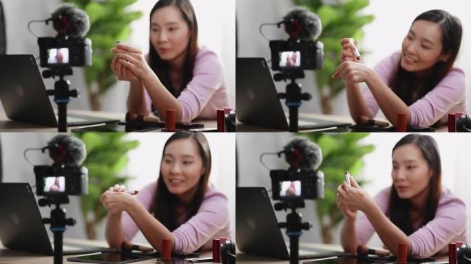 年轻的亚洲女性在她的化妆品视频博客上化妆教程