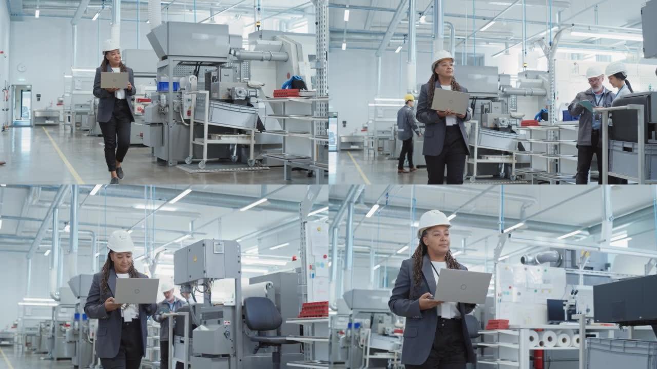 一位非洲女工程师在电子制造工厂戴着安全帽行走和使用笔记本电脑的肖像。处理日常任务和研发数据的技术人员