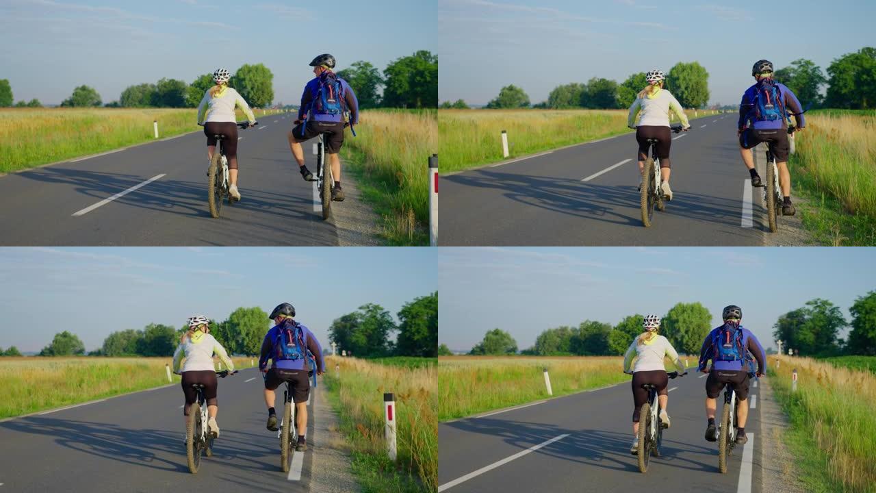 SLO MO夫妇在乡间小路上骑自行车