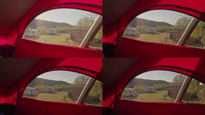 从露营车的一楼看，带窗户的红色屋顶，露营地上有很多货车，面包车生活
