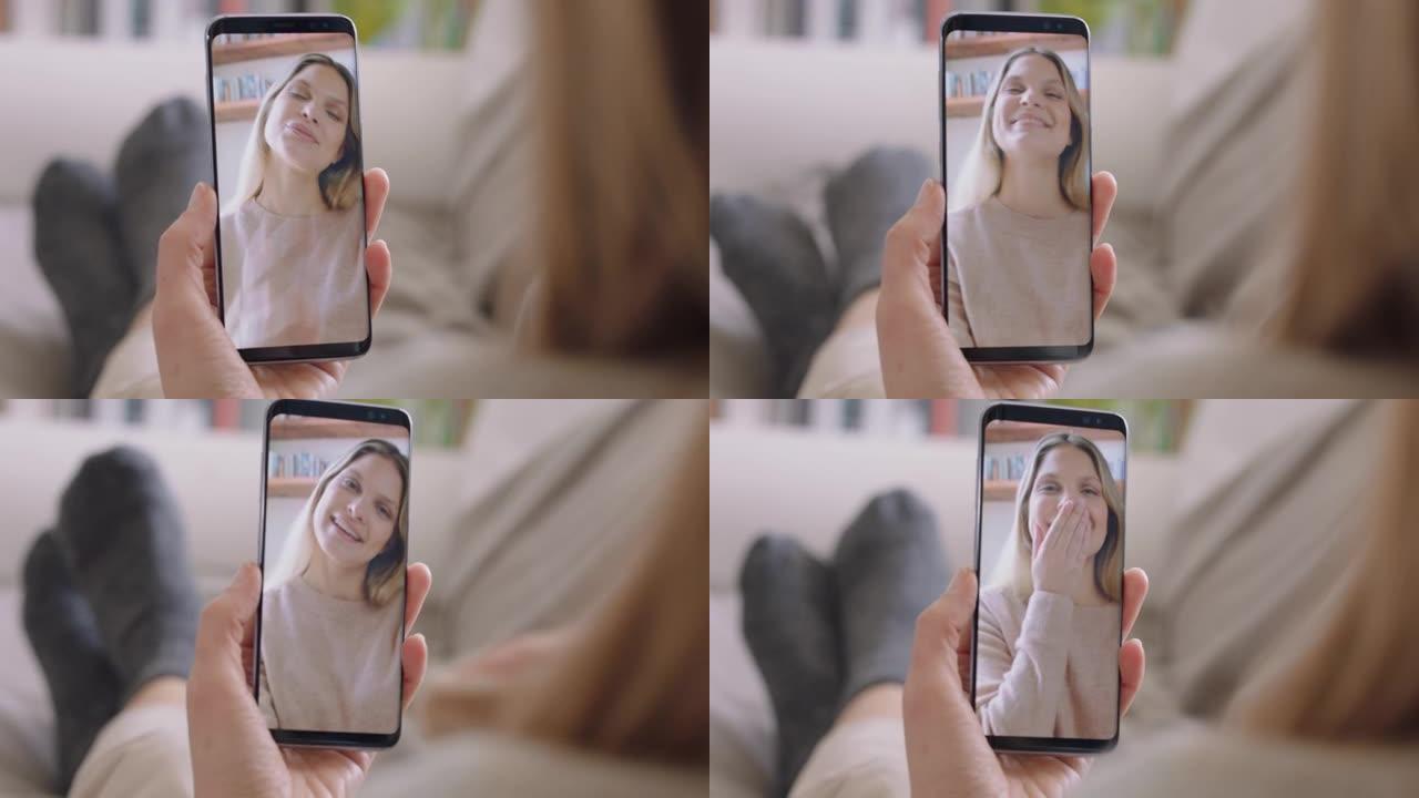 年轻女子在家中使用智能手机进行视频聊天，与朋友聊天，享受对话分享手机垂直方向的生活方式4k镜头
