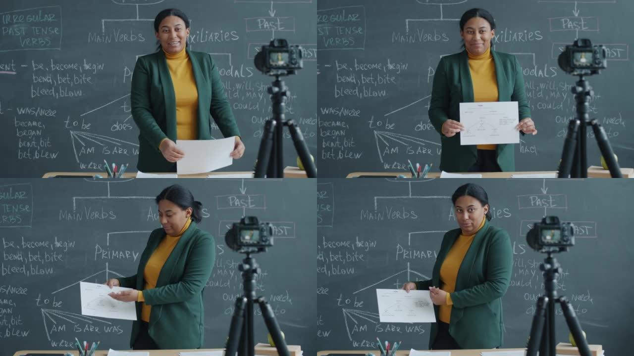 非裔美国妇女在教室里教英语，并用摄像机录制课程
