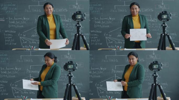 非裔美国妇女在教室里教英语，并用摄像机录制课程