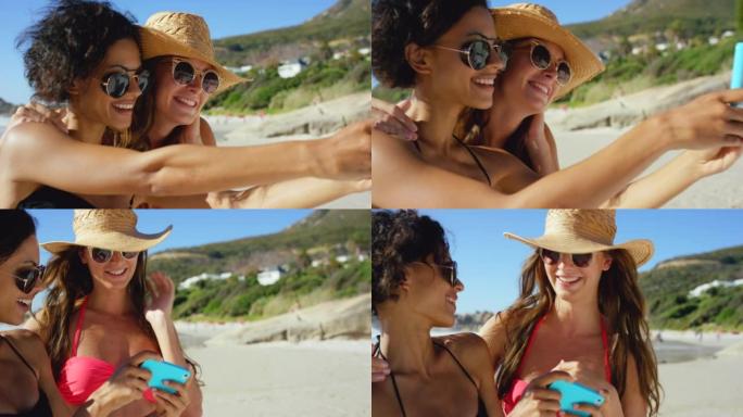 两个迷人的年轻朋友一起站在海滩上并在手机上自拍的4k视频片段