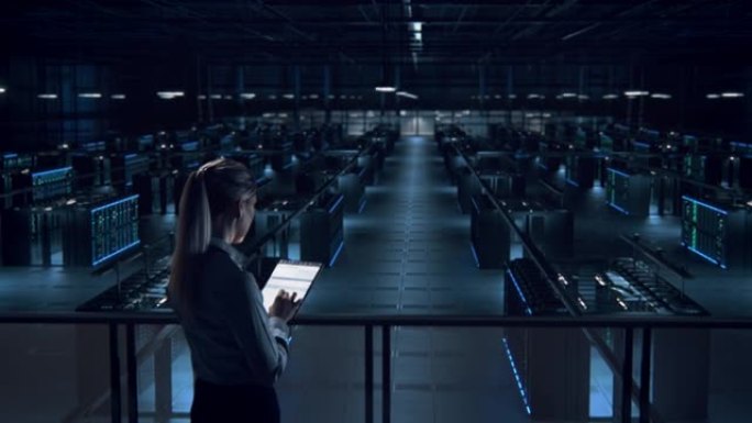 女性IT专家在数据中心使用平板电脑。服务器场云计算设施，维护管理员工作。从事个人网络保护工作的网络安