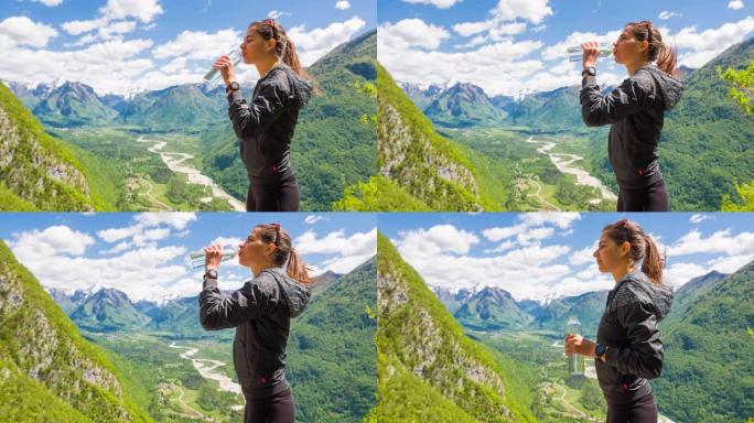 女人从山上徒步旅行中休息，用水瓶喝水