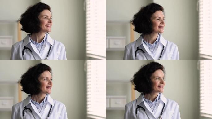 成熟的全科医生女人微笑看着窗外