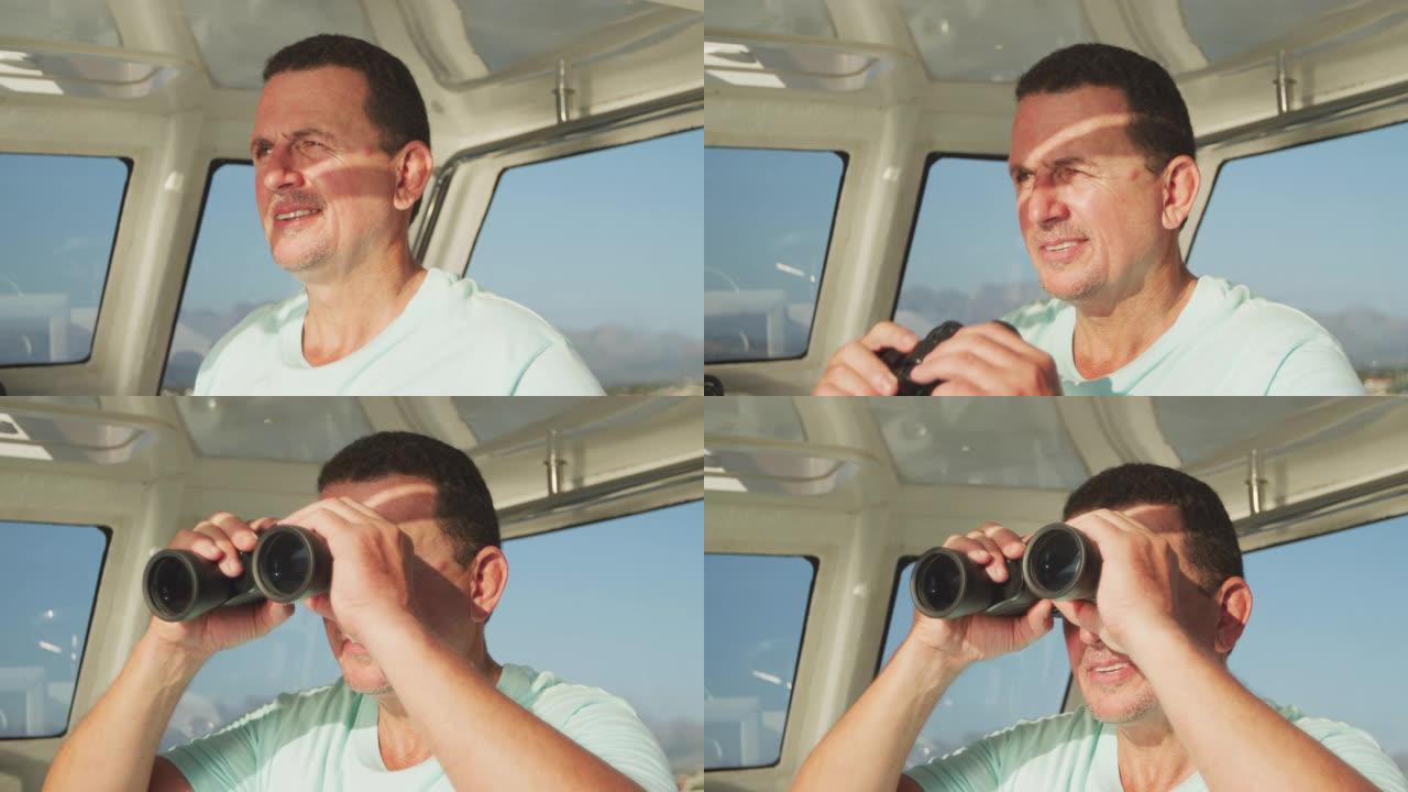 在船上拿着和使用双筒望远镜的高加索人的前视图