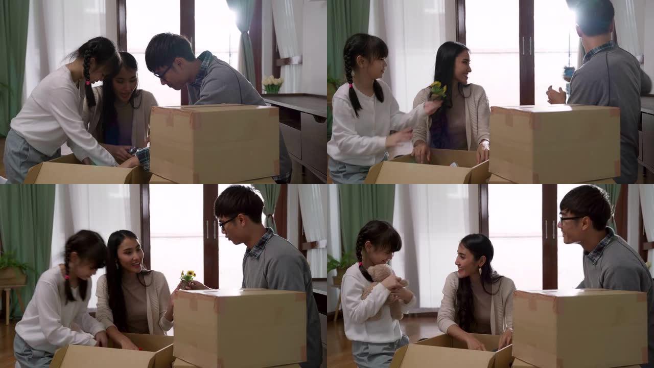 4K UHD多莉拍摄: 快乐的亚洲多代家庭在搬到新家公寓后打开纸板箱。