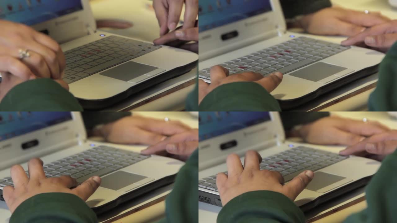 盲人或视障学生的手在盲人学校的课堂上学习使用计算机。特写。