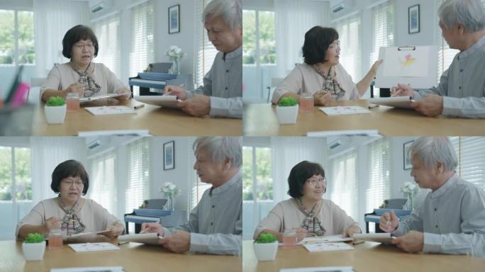 迷人的年轻亚洲公民夫妇坐在家里水彩画艺术品桌子上，在精神卫生治疗或亚洲老年人检疫活动生活方式概念中感