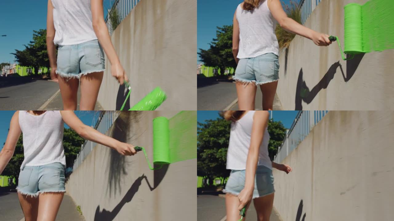 年轻女性艺术家用绿色油漆绘画墙壁行走在城市街道上独立女性享受城市涂鸦艺术表达4k