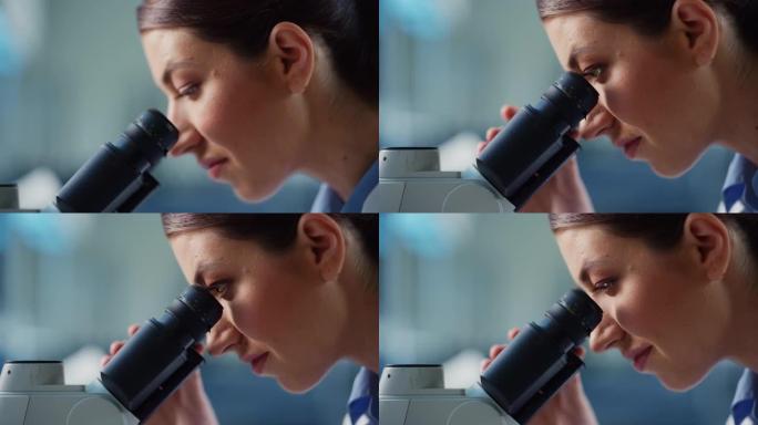 宏观特写一位美丽的女科学家看着显微镜的镜头。用技术设备在现代实验室中研究分子样品的女性微生物学家。
