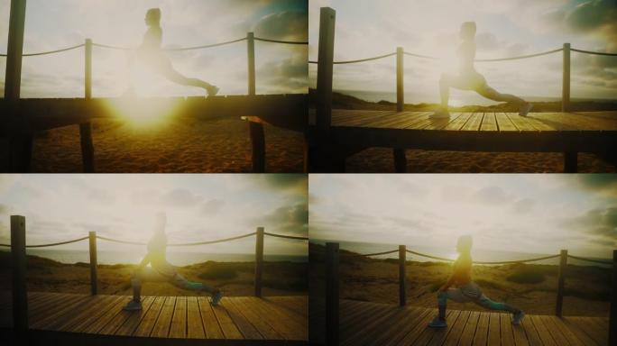 日落时，手持，倾斜，慢动作拍摄无法辨认的健美女运动员在木板路上伸展