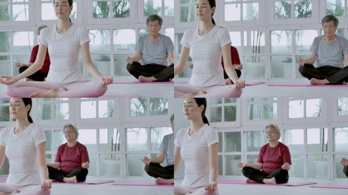 亚洲的多代家庭做瑜伽到家庭锻炼。家庭，生活方式，人，多代，老人，假期，关系，孩子，退休，健康护理，领