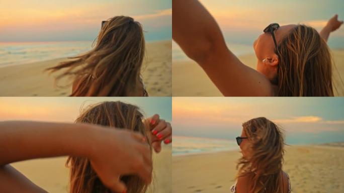 年轻女子女士在日落时欣赏海滩美景时将头发向后翻转