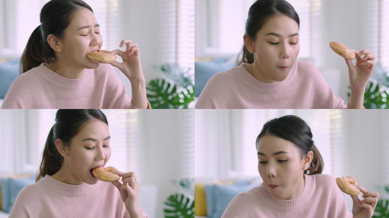 亚洲妇女在家吃甜甜圈