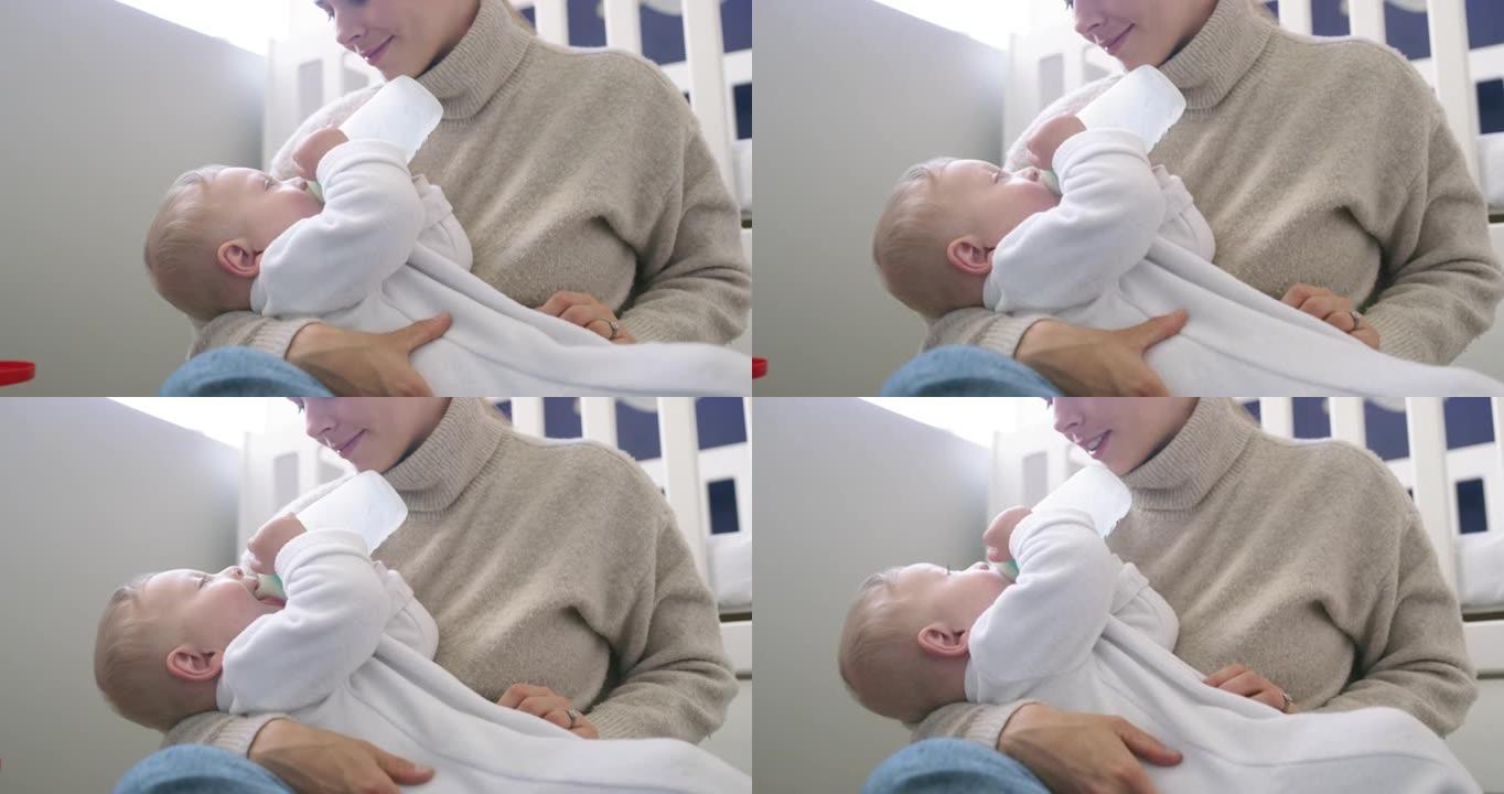 4k视频片段，一个可爱的男婴在家中被母亲喂奶瓶