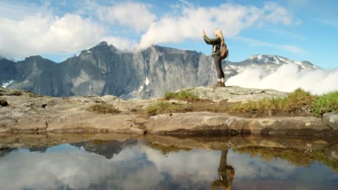 4k视频片段，一个无法识别的女人在m ø re og Romsdal远足时欣赏山景
