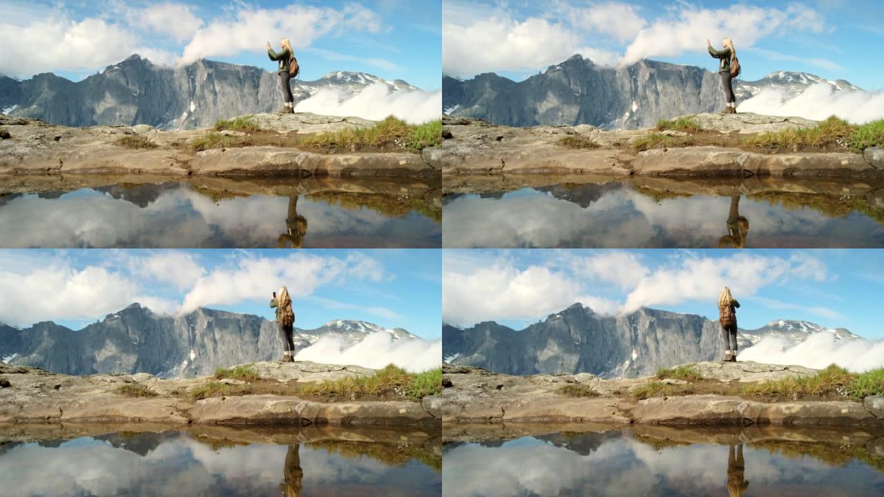 4k视频片段，一个无法识别的女人在m ø re og Romsdal远足时欣赏山景