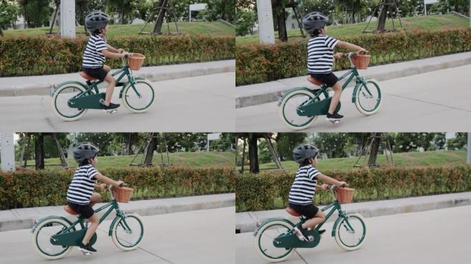男孩骑自行车。小孩骑自行车