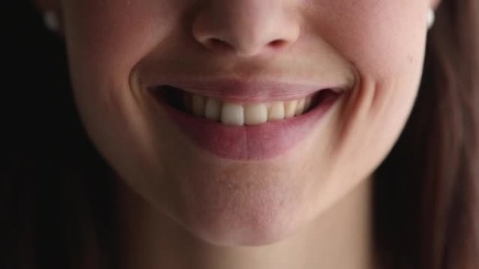 拥有健康完美洁白牙齿的微笑女人的特写脸