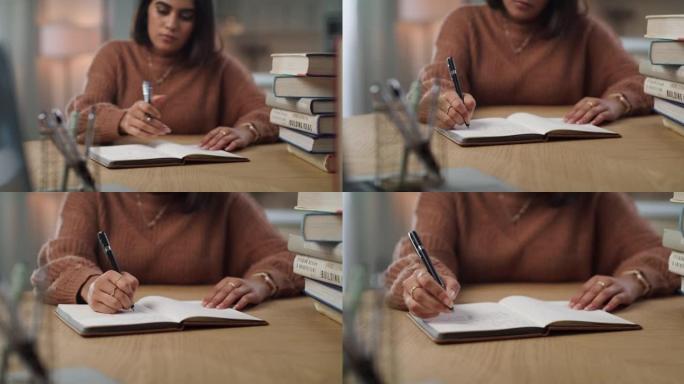 4k视频片段，一个迷人的年轻女子独自坐在家里，在学习时在书中写笔记