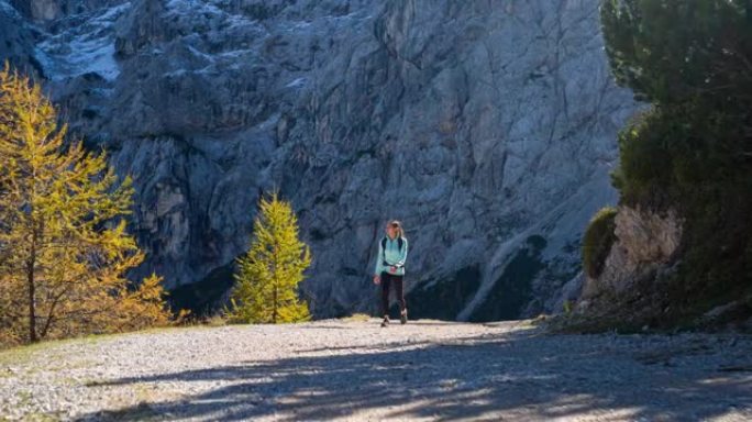 健康的女运动员保持健康的生活方式，在周围风景优美的山区徒步旅行